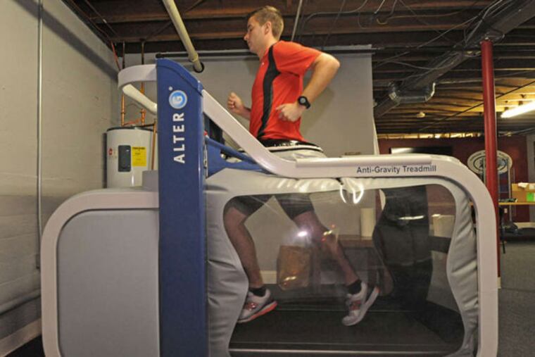 Ralph Harris of the Running Company of Haddonfield demonstrates the Alter G antigravity treadmill, which NASA developed to simulate weightlessness. APRIL SAUL / Staff Photographer