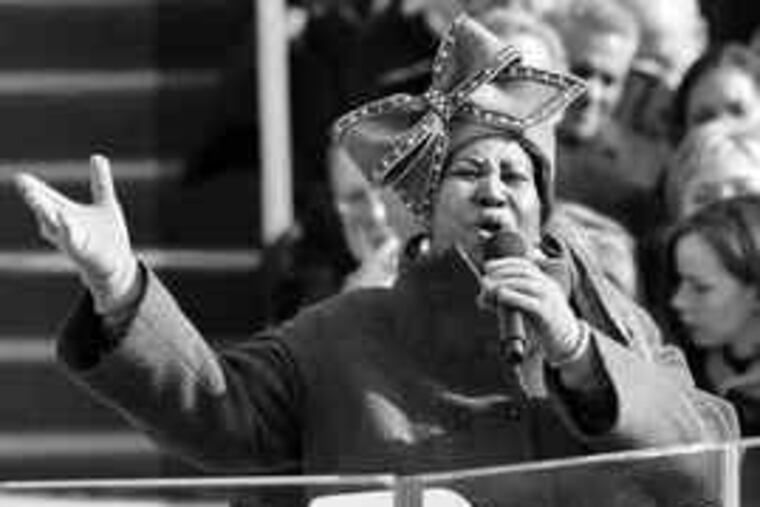 Featured soloist Aretha Franklin, in glittery headgear, performs during the swearing-in ceremony.
