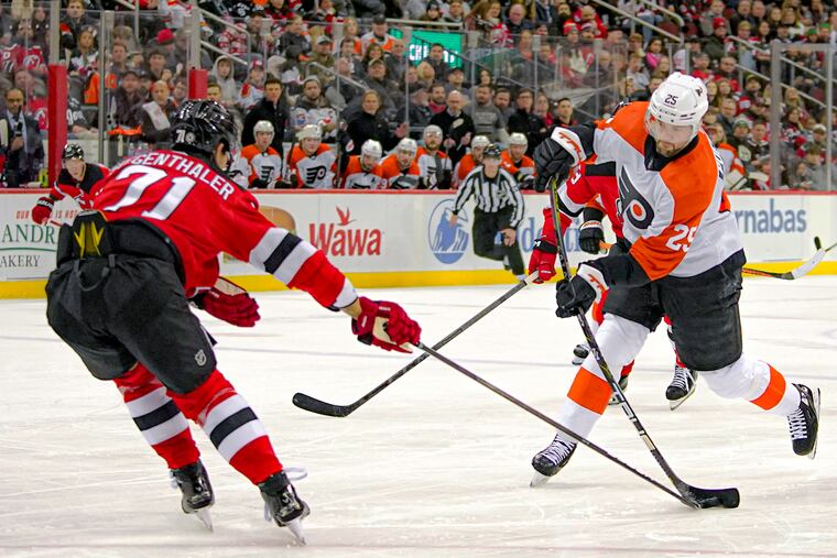 Devils defenseman Jonas Siegenthaler blocks the shot of Flyers center Ryan Poehling during the first period on Dec. 19.