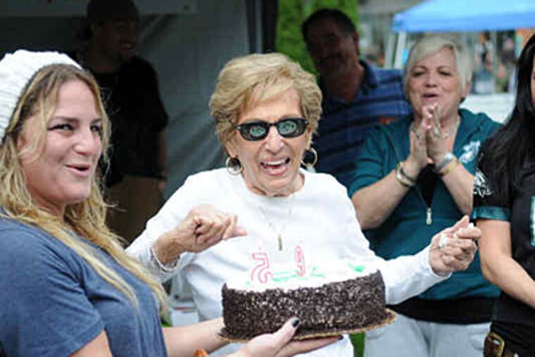 Eagles fan Bianca Antonini (center, with sunglasses), 95, gets a cake from granddaughter Janine Antonini. (Kriston Bethel / Staff)