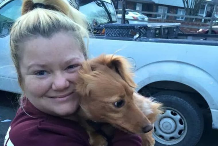 Ollie, who disappeared after fighting off an intruder at his owners' home Dec. 28, has been reunited with his owners, including Nicole Donlen, pictured. (Family photo)