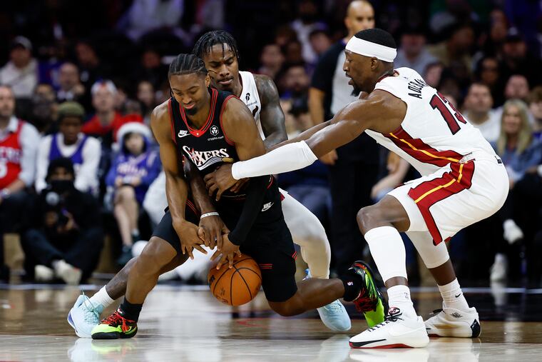 Sixers guard Tyrese Maxey loses the basketball as he is defended by Heat center Bam Adebayo.