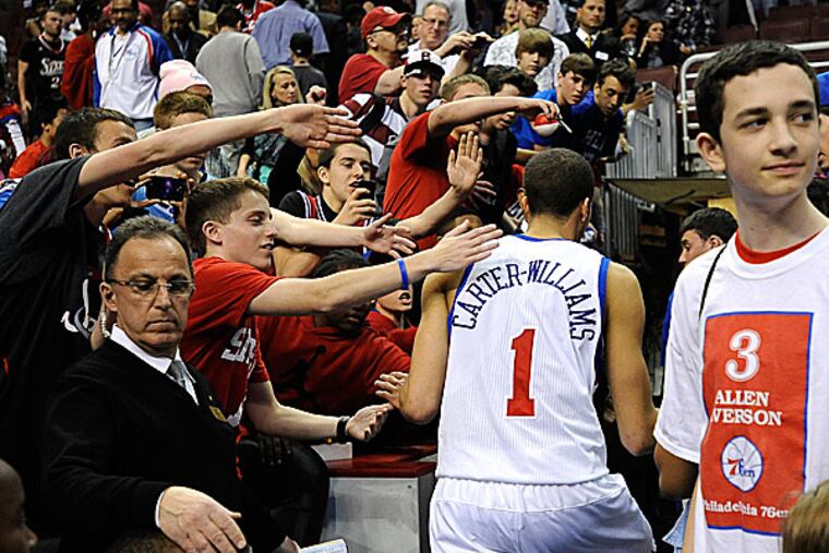 The 76ers' Michael Carter-Williams celebrates with fans. (Michael Perez/AP)