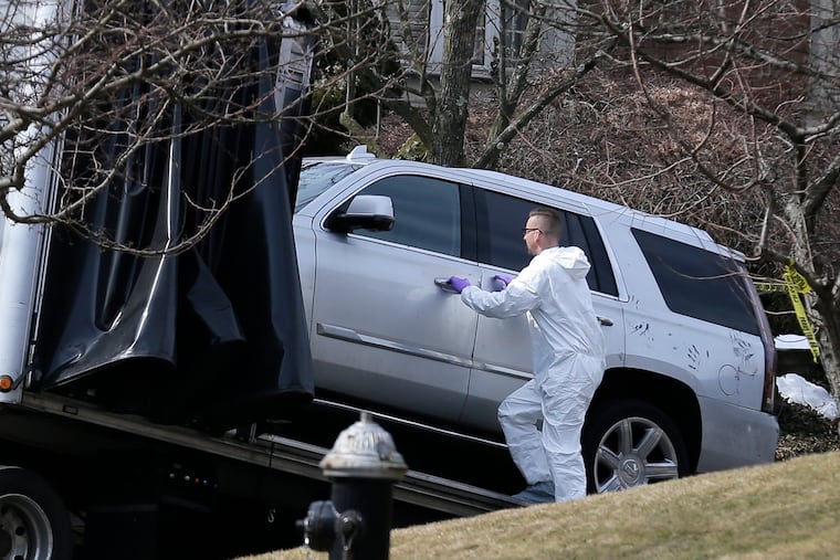 Crime scene investigators load a car that appears to have been checked for fingerprints onto a flatbed truck in the Staten Island borough of New York, Thursday, March 14, 2019. Francesco "Franky Boy" Cali was found with multiple gunshot wounds at his red-brick colonial-style house on Staten Island on Wednesday night and was pronounced dead at a hospital.