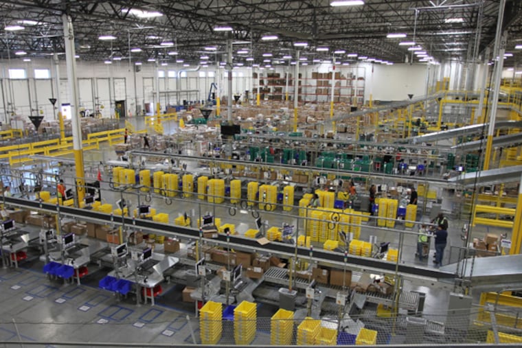 People at work at the Amazon San Bernardino Fulfillment Center, Tuesday October 29, 2011 in San Bernardino, California. The 1 million-square-foot facility was the first of 40 planned facilities across the country and the first of two in California. (AP Photo/David McNew)
