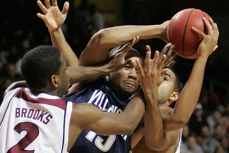Temple's Ryan Brooks (2) and Luis Guzman (right) pressure Villanova's Reggie Redding in the teams' December 2007 meeting.