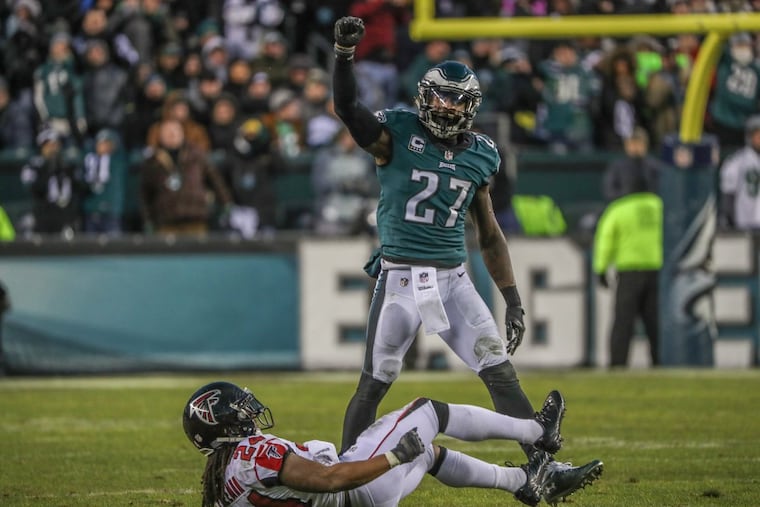 Safety Malcolm Jenkins exults after stopping the Falcons' Devonta Freeman short of a first down. MICHAEL BRYANT/ Staff Photographer