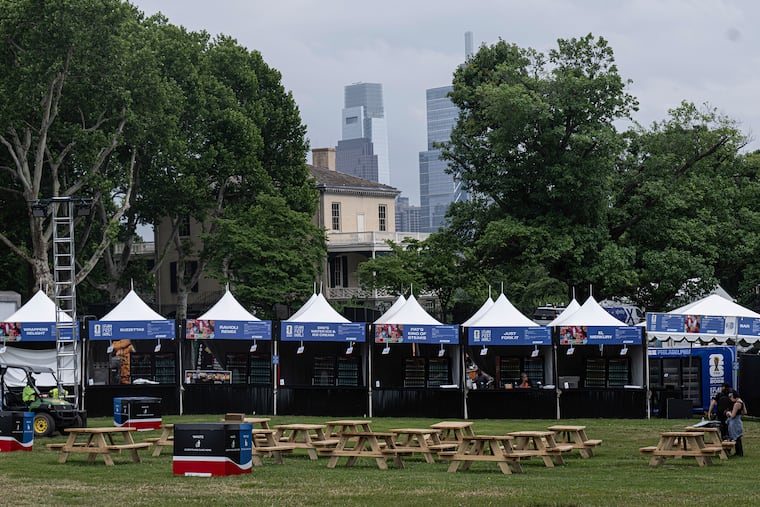 Crew members make final preparations, including work on a 60-foot-wide screen, for the FIFA Fan Fest at Lemon Hill, which begins Thursday.