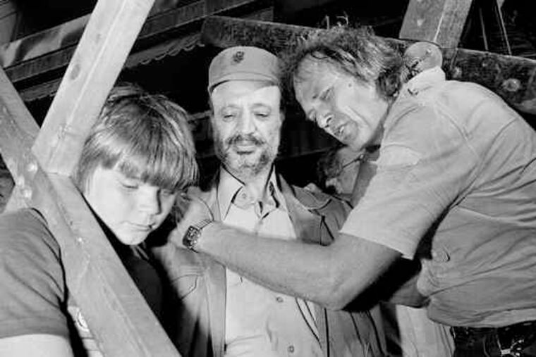 Arthur Blessitt, of Los Angeles, is seen praying with his son, Joshua, and the late Yasser Arafat (center) in Beirut, Lebanon, on July 4, 1982.