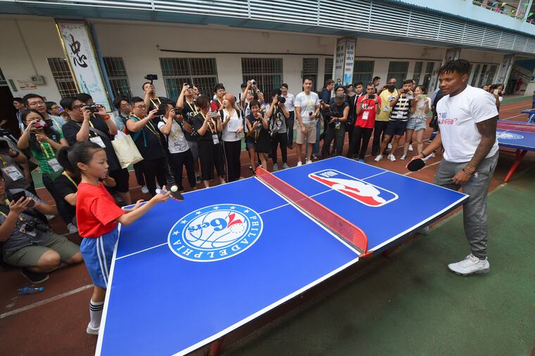 Markelle Fultz plays ping-pong with a student at a community service event at the Shenzhen Nanshan Lishan School in Shenzhen, China.