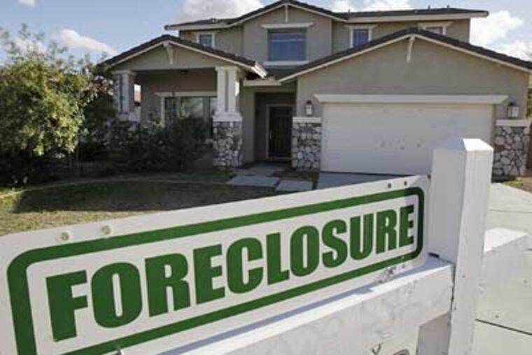 A foreclosure sign sits outside a home for sale in Phoenix on Tuesday. With one of the highest foreclosure rates in the country, Arizona makes a fitting backdrop for President Barack Obama's new housing program. (AP Photo/Ross D. Franklin)