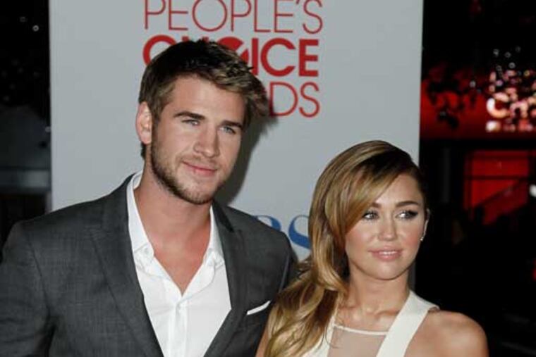 Liam Hemsworth (left) and Miley Cyrus in 2012. (AP Photo/Matt Sayles)