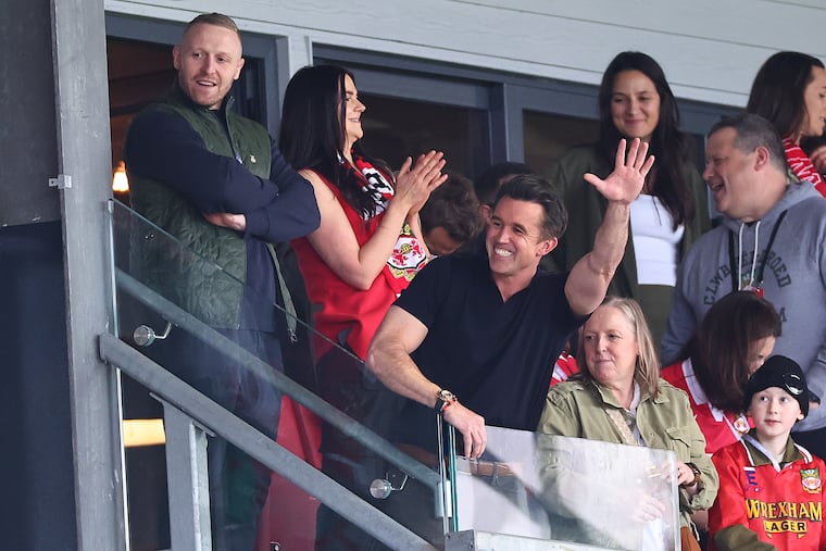 Rob Mac waving to fans at a Wrexham game last season.