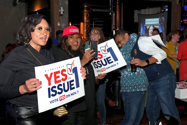 Hamilton County Commissioner Alicia Reece, second from left, joins voters in reacting to the passage of Ohio Issue 1, a ballot measure to amend the state constitution and establish a right to abortion, at an election night party hosted by the Hamilton County Democratic Party, on Nov. 7 in Cincinnati.