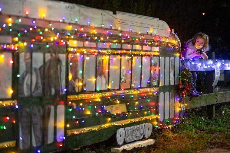 The historic Route 15 trollies have been temporarily replaced by buses, which means no jolly trolley this year. A group of neighbors and artists recently got together to decorate a replica of the trolley to spread some cheer during a very dismal year. Margaret Wilbur, 2, checks out the festive trolley with famous riders on Nov. 21, 2020.