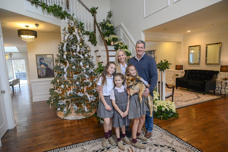 With the help of the Norristown Garden Club, the Doyle family (from left) Ynez, Lena, mom Alicia Ondik, Rose the dog, Daphne, and dad Bill are ready for Christmas.
