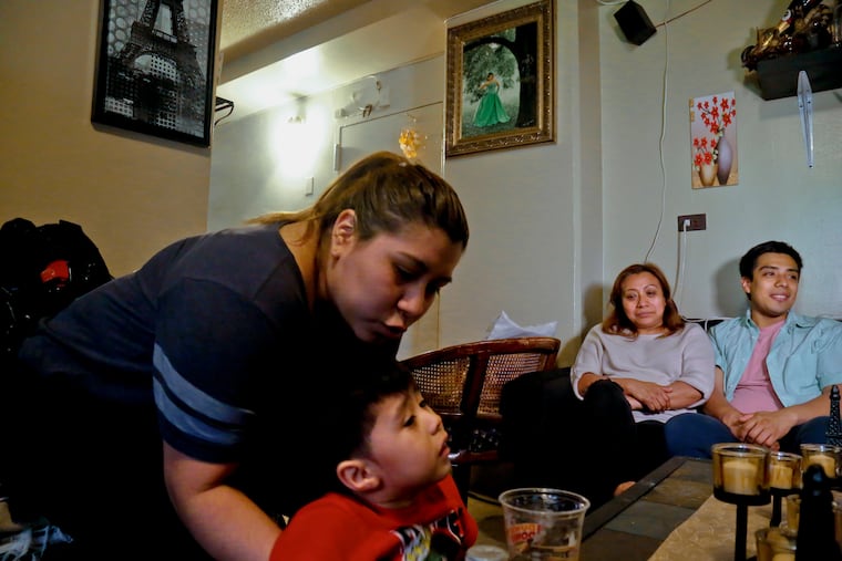 Rosa (second from right) who wants her last name withheld, is an undocumented immigrant who used to get about $190 per month from the Supplemental Nutrition Assistance Program, or SNAP. She stopped taking benefits fearing deportation. She is surrounded by her son Edgar (far right), daughter Olga (far left), and grandson Logan at their home during a 2017 interview in New York.