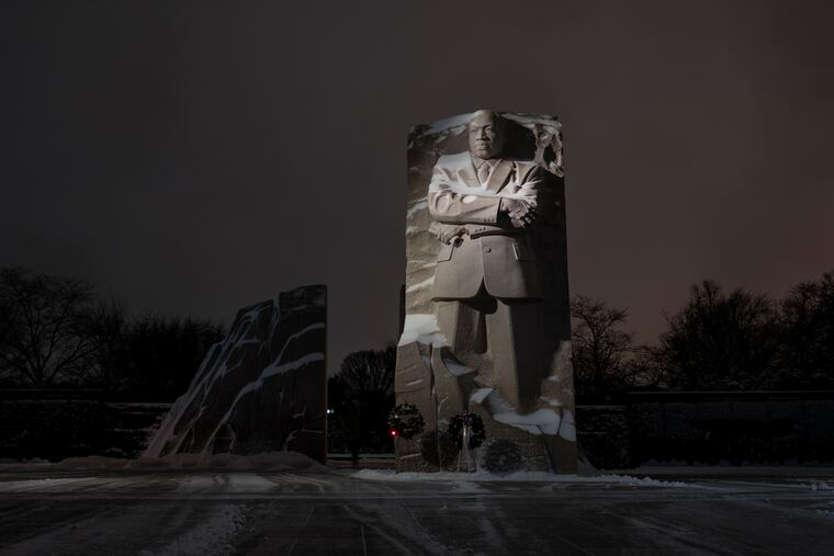 Snow covers the Martin Luther King Jr. Memorial in Washington on Sunday.