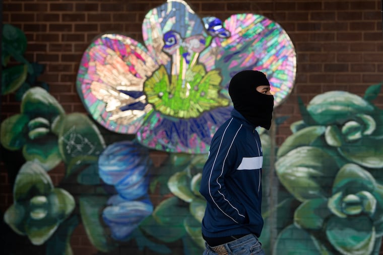A pedestrian wears a balaclava ski mask to shield himself from the cold air along Columbus Boulevard in Philadelphia. City Council voted to ban the masks in certain public places.