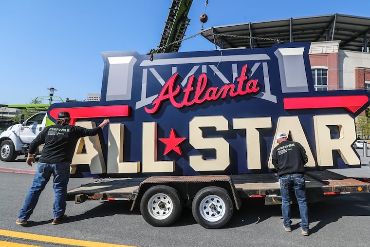 Workers load an All-Star sign onto a trailer after it was removed from Truist Park in Atlanta in April 2021.