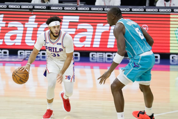 Sixers guard Seth Curry, dribbling against Hornets center Bismack Biyombo, has been a solid three-point shooter so far.