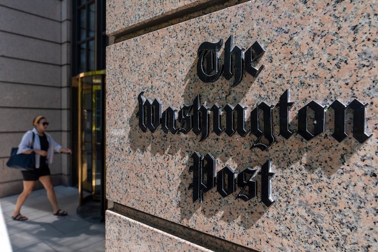 A person walks into the One Franklin Square Building, home of The Washington Post in Washington, D.C.