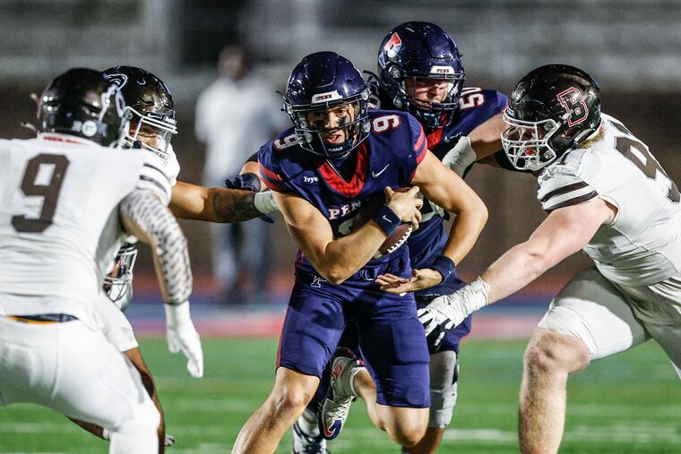 Penn quarterback Aidan Sayin, seen here in action against Brown, threw for 215 yards in a triple-overtime loss to Harvard on Saturday.