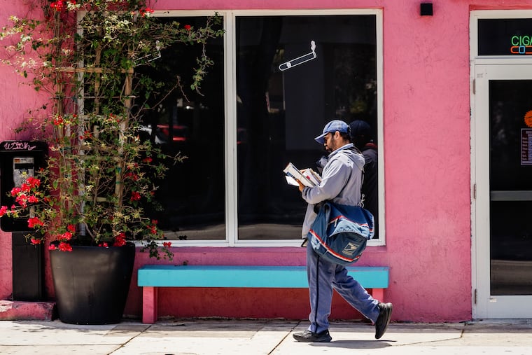 FILE — A United States Postal Service (USPS) worker makes deliveries in Miami, April 28, 2025. The U.S. Postal Service, confronting a bleak financial shortfall that had threatened to starve it of the cash to keep operating within months, has shored up its finances enough to avoid insolvency for at least “several years,” postal regulators said on Thursday, June 4, 2026.