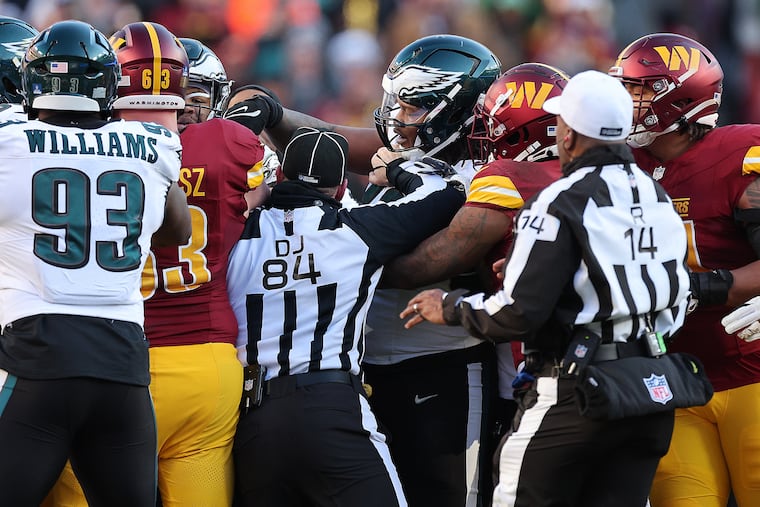 Jalen Carter (center) and the Eagles defense conceded multiple big plays Sunday against the Commanders.
