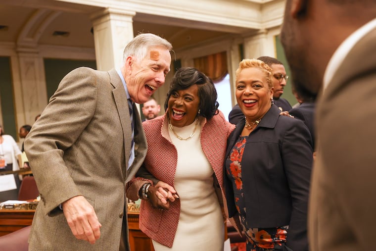 Philadelphia Mayor Cherelle L. Parker laughs and hugs city councilmembers Brian O’Neill and Cindy Bass after she delivered her first budget address in City Council chambers in Philadelphia, Pa. on Thursday, March 14, 2024.
