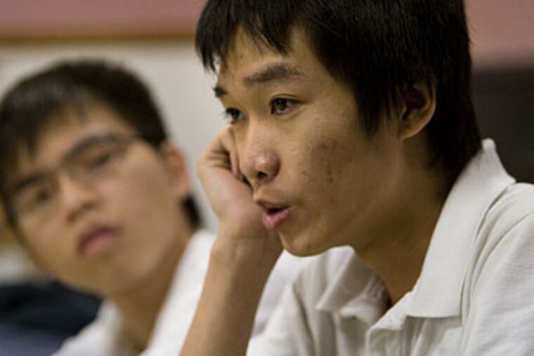 Duong Ly (left), 18, and Bach Tong, 16, during an interview at Victims Witness Services of South Philadelphia on March 5. ( David M Warren / Staff Photographer )
