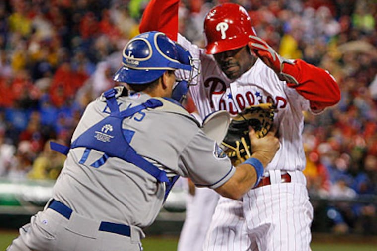 Jimmy Rollins is tagged out at home after a Placido Polanco ground ball in the fifth inning. (Ron Cortes/Staff Photographer)