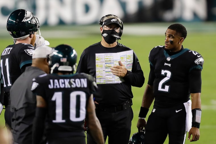 Eagles coach Doug Pederson holds his play chart as he decides what to do on fourth-and-goal. They did not score on the play.