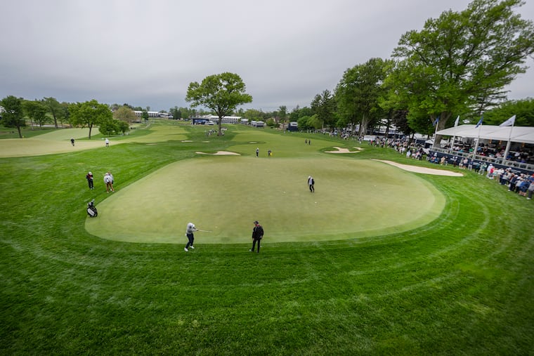 Justin Thomas chips onto the 18th green during a practice round ahead of the PGA Championship at Aronimink Golf Club on a dreary Monday. It's going to get better.