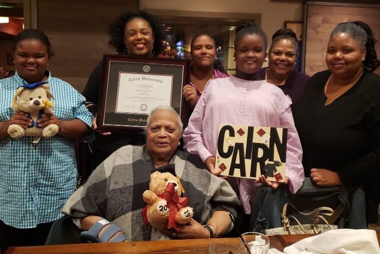 Mrs. Robinson (seated) and family members celebrate the graduation from Cairn University of granddaughter Diamond Franklin (second from left) in 2019.