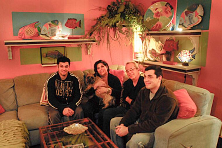 The Moretti family (from left to right) Josh, Christine, Al and Jeremy sit in the brightly colored living room of their Somerton home. (Ron Tarver / Staff Photographer)