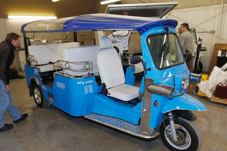 A worker checks the roof on an electric tuk-tuk in Denver. An Amsterdam firm has signed a licensing agreement with Denver-based eTuk USA to allow the U.S. company to manufacture and sell an electric version of the vehicle.