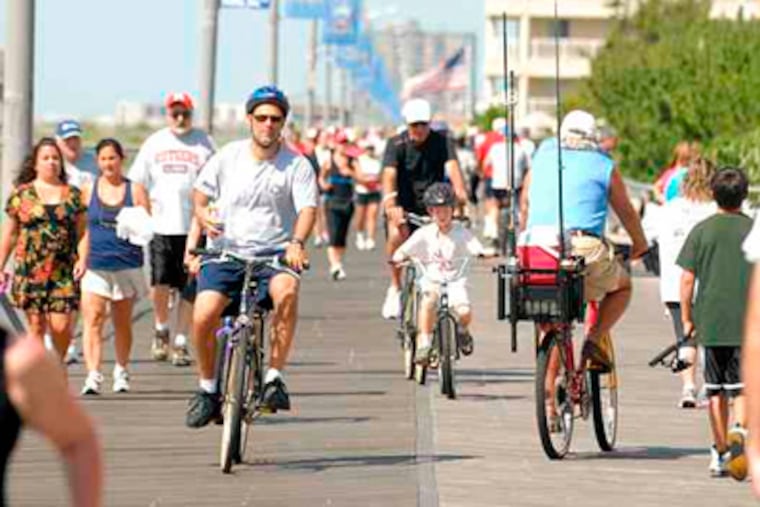 Bikers and walkers share the crowded Ventnor boardwalk, where scofflaws might have an easier time this summer. (Ron Tarver / Staff Photographer)