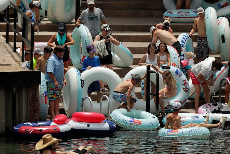 Tubers prepared to float the Comal River despite the recent spike in COVID-19 cases Thursday in New Braunfels, Texas.