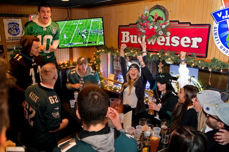 Philadelphia fans at Locust Rendezvous Bar & Grille (15th & Locust) react as the Saints miss a 52-yard field goal in the final minutes of the Eagles Divisional playoff game loss to New Orleans January 13, 2019. All friends from the Fairmount neighborhood, Ryan Brown (jersey #10) is standing next to the TV. Below him is Kevin DeLorenzo (jersey #11), and Mike Edmond is seated under the TV. Rachel Djaraher is at right, with both arms lifted.