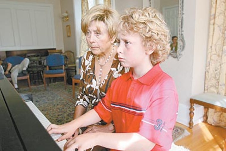 Carson Atlas, 8, works on his keyboard skills under the tutelage of piano teacher Nelly Berman. The Haverford third grader will be a finalist in the “Classical Music Idol” competition in May. (CHARLES FOX / Staff Photographer)
