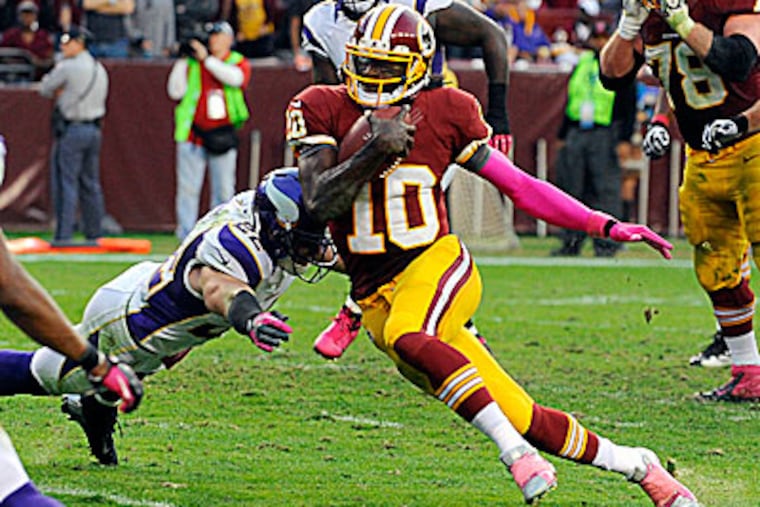 Redskins quarterback Robert Griffin III ran for two touchdowns in a win over the Vikings Sunday. (Richard Lipski/AP)