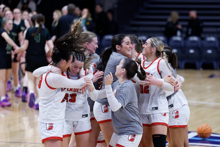 Archbishop Carroll players celebrate after beating Archbishop Wood in the Catholic League girls' basketball semifinals on Monday at Villanova's Finneran Pavilion.