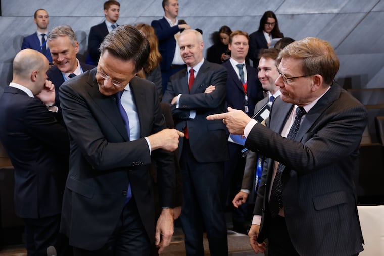 Germany's Foreign Minister Johann Wadephul (right) speaks with NATO Secretary General Mark Rutte during a meeting Wednesday at NATO headquarters in Brussels, Belgium.