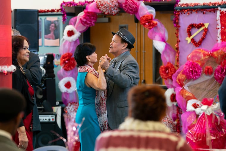 Minerva Miranda, left, and Antonio Jimenez, right, dance together at a Valentine's Day Dance at the Norris Square Senior Community Center.