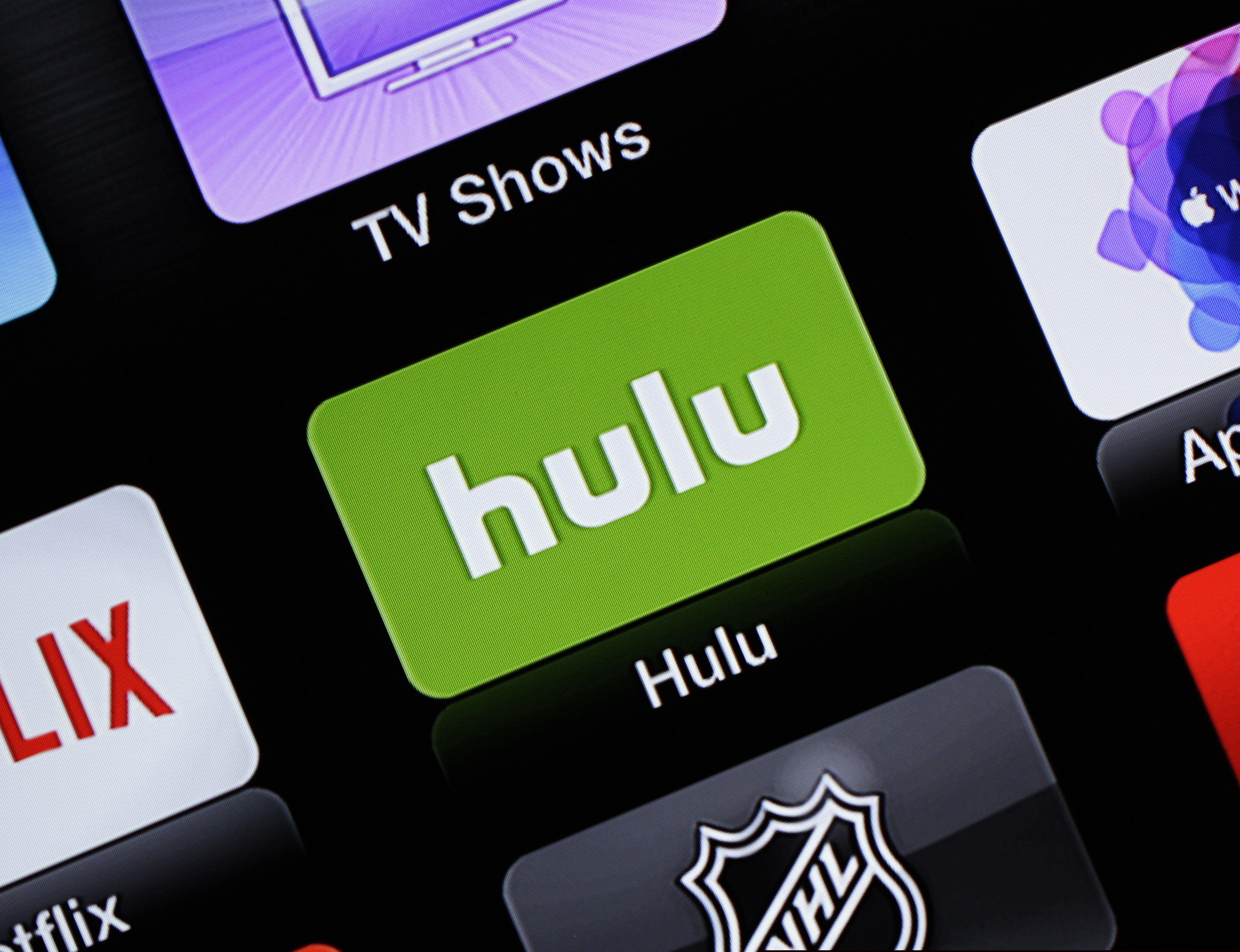 FILE- This June 24, 2015, file photo shows the Hulu Apple TV app icon in South Orange, N.J. AT&T has sold its 9.5% share in Hulu back to the streaming TV company, leaving Disney and Comcast as its sole owners. (AP Photo/Dan Goodman, File)