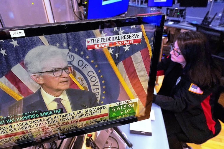 The news conference of Federal Reserve Chair Jerome Powell was displayed May 7 on a screen in the booth of trader Phyllis Arena Woods, on the floor of the New York Stock Exchange.