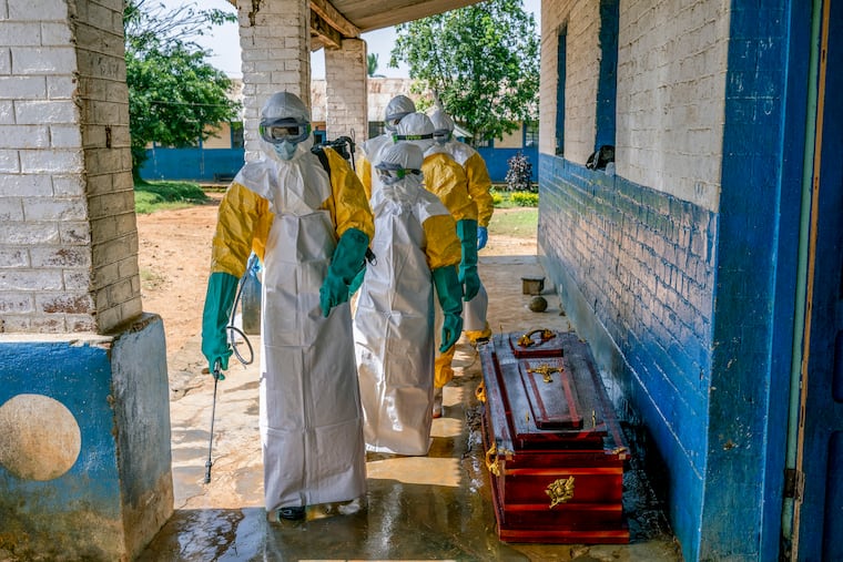 Health workers disinfect a coffin containing the body of a man presumed to have died of Ebola at a hospital in Mongbwalu, Democratic Republic of Congo, May 25, 2026.