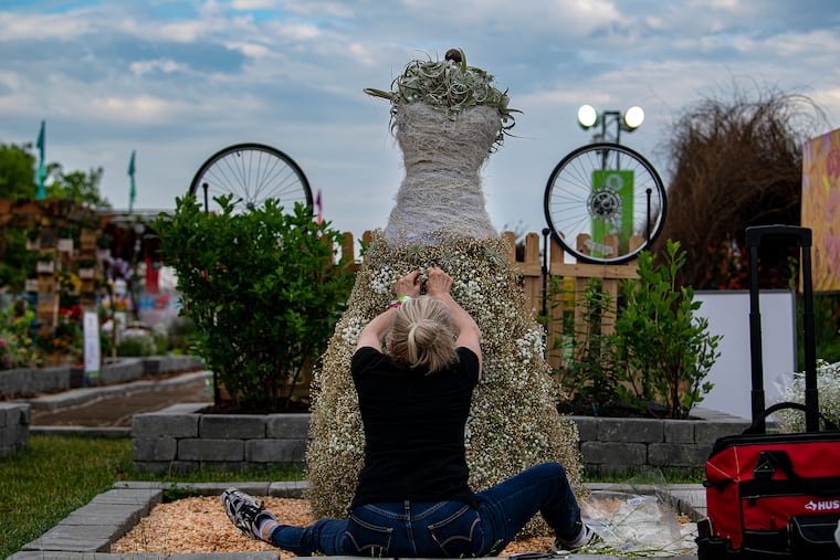 Flower designer, Bobette Leidner Fisk works on her floral arrangement in preparation for the 2022 Philadelphia Flower show at FDR Park.