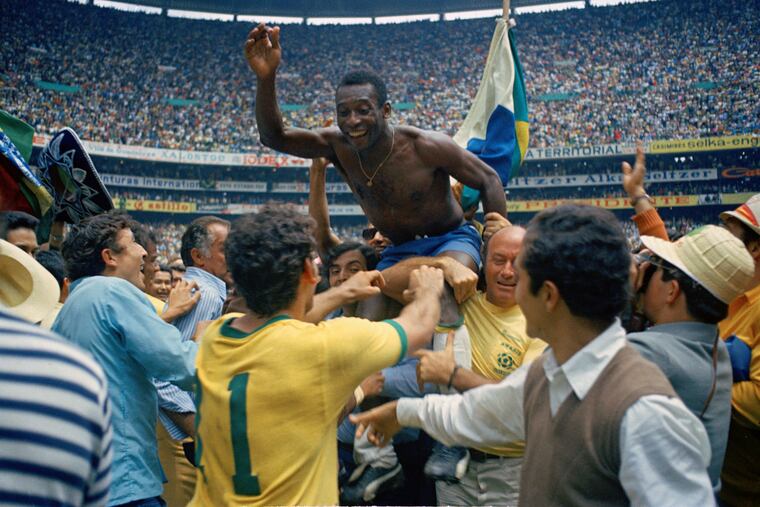 Pelé is hoisted on the shoulders of his teammates after Brazil won the World Cup final against Italy, 4-1, in Mexico City's Estadio Azteca in 1970. Pelé died on Thursday.